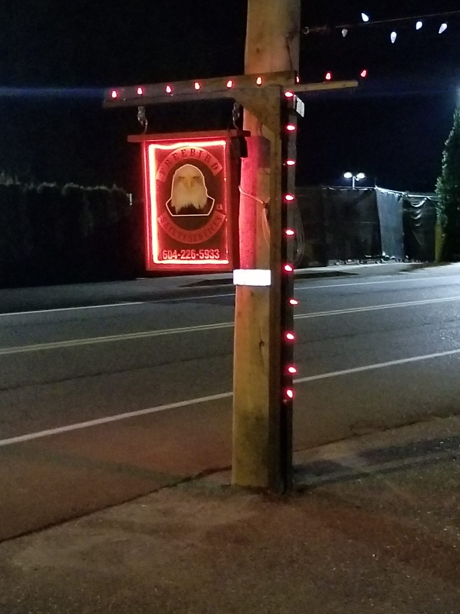 company street sign at night lite up with red led lights