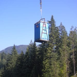 job site outhouse being craned out of the damn area